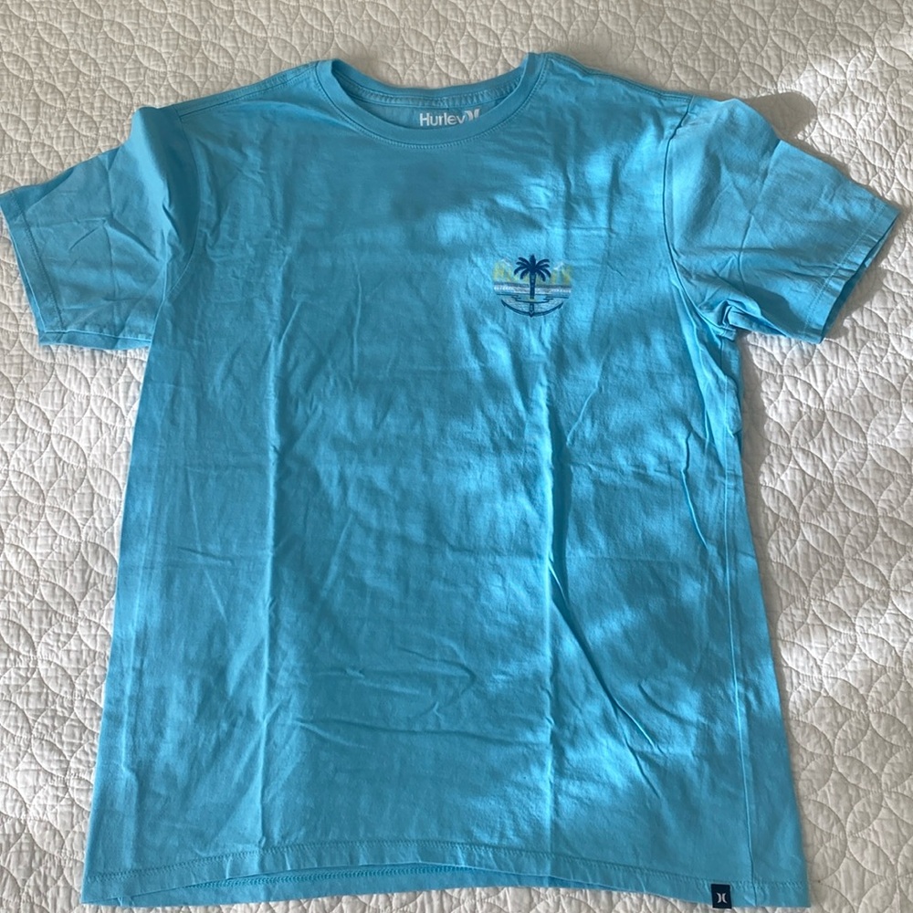 Men’s medium Hurley tee is aqua blue with palm tree.  Washed but never worn.